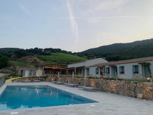 a swimming pool in front of a house at Tenuta Paltusa in Calangianus