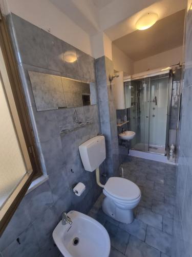 a bathroom with a toilet and a sink at Il Borgo Apartment in Pignone