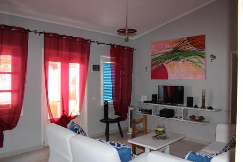 a living room with red curtains and a table at Free Zone in Annunziata