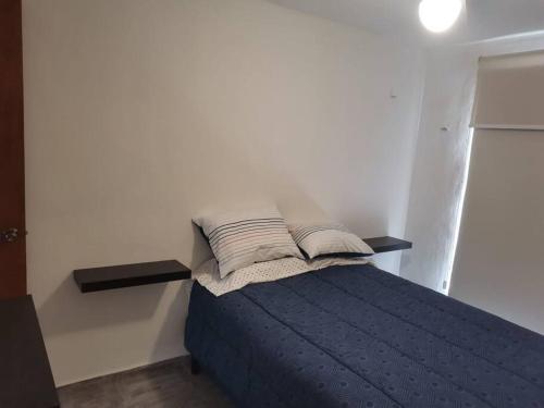 a bedroom with a bed with two pillows on it at Gran Plaza, Cancún in Cancún