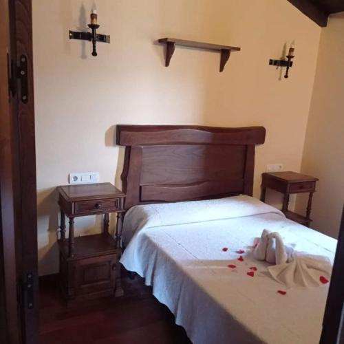 a bedroom with a bed with roses on it at Apartamento" El Carballo" in San Tirso de Abres