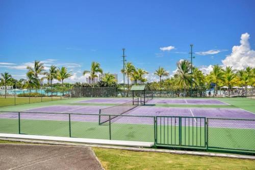 two tennis courts with palm trees in the background at Playa Blanca Ocean in Río Hato