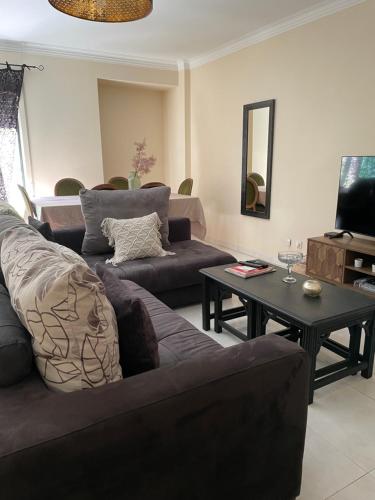 a living room with a couch and a table at Apartamento Alcochete in Alcochete