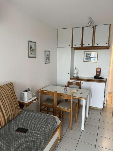 un salon avec une table et une cuisine dans l'établissement Appartement Village Vacances Cap Esterel, à Saint-Raphaël