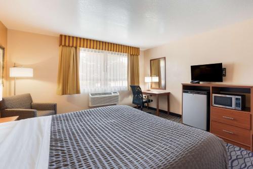 a hotel room with a bed and a television at SureStay Hotel by Best Western Wenatchee in Wenatchee