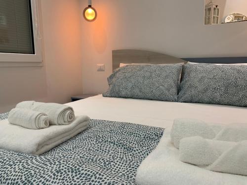 a bedroom with a bed with towels on it at Acquamarina Casa Vacanze in Marina San Vito