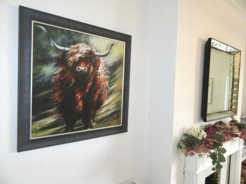 a painting of a bull hanging on a wall at Stylish 3 Bedroom City Retreat in Perth