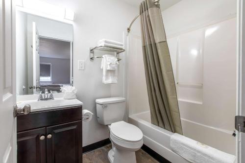 a bathroom with a toilet and a sink and a shower at Suburban Studios Spartanburg - I-26 in Spartanburg