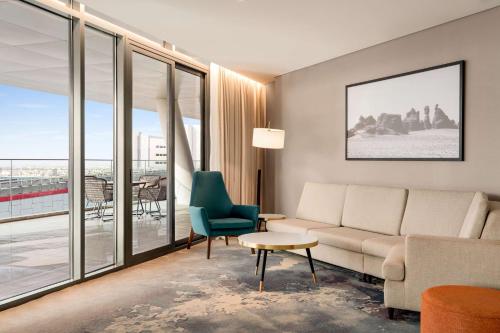 a living room with a couch and a chair at Radisson Blu Hotel Riyadh Convention and Exhibition Center in Riyadh
