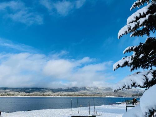 a view of a lake with snow on the ground at Cozy Bear Chateau -Beautiful Moonridge home nestled in the pines and birches in Big Bear Lake