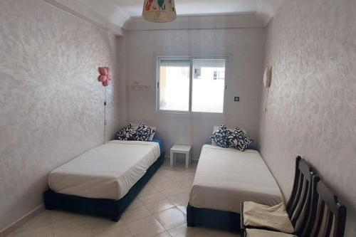 um quarto com 2 camas e uma janela em Very beautiful appart to make your trip special em Casablanca