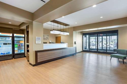 an empty lobby with a drink bar and chairs at MainStay Suites North - Central York in York