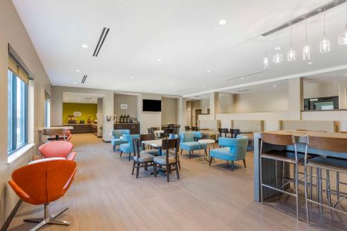 a waiting room with colorful chairs and tables in a building at MainStay Suites North - Central York in York