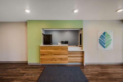 an empty room with a large mirror and a desk at WoodSpring Suites West Palm Beach in West Palm Beach