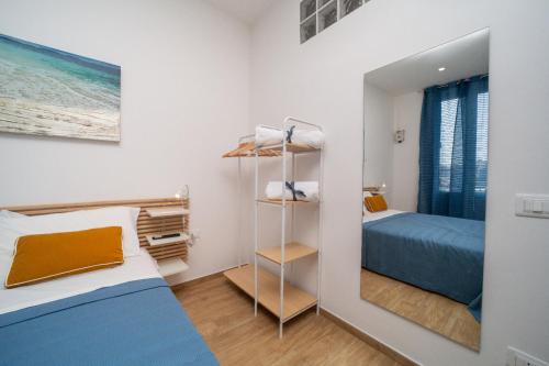 a small bedroom with a bed and a mirror at Lovely Palermo in Palermo