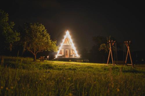 a lit up building in a field at night at Blackcherry_Ukraine in Chereshenka