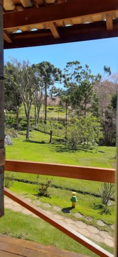 a view of a giraffe from a window at Chalé Caminho da Montanha in Gonçalves