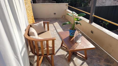 a patio with a chair and a table on a balcony at La Belle San Isidro Lofts in San Isidro