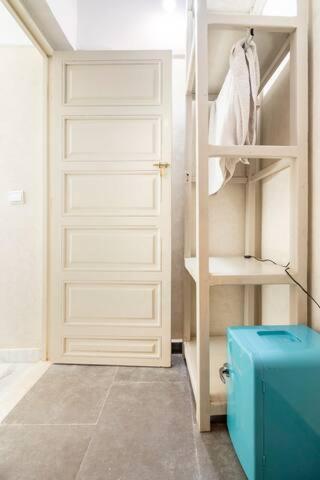a closet with a white door and a blue suitcase at Douiria salix agafay in Marrakech
