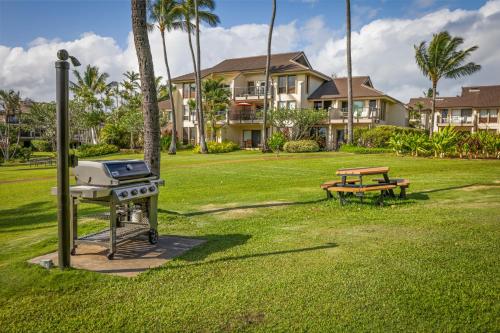 a grill and a picnic table in a park at Aston At Poipu Kai in Koloa