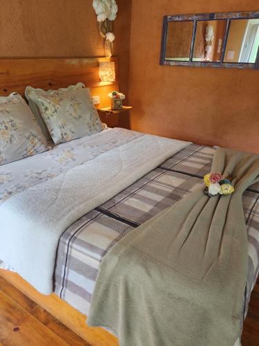 a bed with two stuffed animals sitting on top of it at Pousada Vale Monte Azul in Santo Antônio do Pinhal