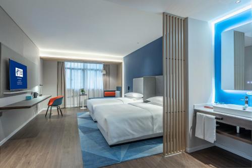 長沙市にあるHoliday Inn Express Changsha South Railway Station by IHGのベッドとシンク付きのホテルルーム
