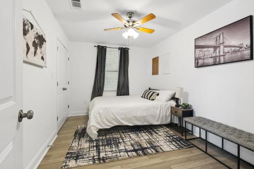 a bedroom with a bed and a ceiling fan at New Luxury 3BR w Jacuzzi in New Orleans