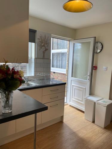 a kitchen with a sink and a counter top at Amazing Studio Room in Ilford! in Ilford