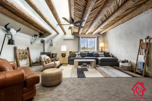 a living room with a couch and a table at Rancho de La Luna Casita in Santa Fe