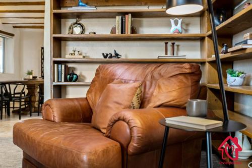 a brown leather couch sitting in a living room at Rancho de La Luna Casita in Santa Fe