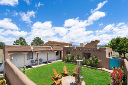 a backyard with chairs and a house at Rancho de La Luna Casita in Santa Fe