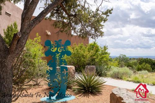 a sign in front of a building next to a tree at Rancho de La Luna Casita in Santa Fe