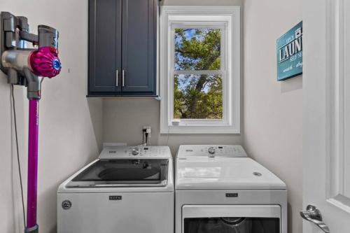 a small kitchen with a stove and a window at Maison by The Sea at Kure Beach in Kure Beach
