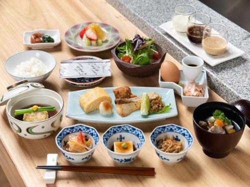 a table topped with plates of food and bowls of food at Bettei Amafuru Oka in Ibusuki