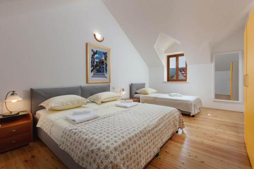 um quarto com 2 camas e uma janela em Family friendly house with a swimming pool Pucisca, Brac - 21243 em Pučišća