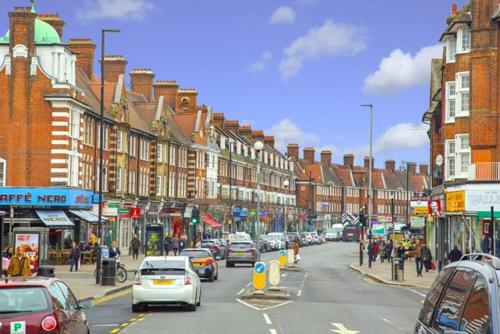 a busy city street with cars parked on the street at Penthouse studio with 2 double beds & smart TV. Great London Location in London