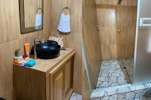 a small bathroom with a sink and a shower at Ceiba Amazon Lodge in Iquitos