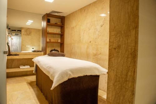 a bathroom with a bed and a sink in a room at Camino Real Monterrey in Monterrey
