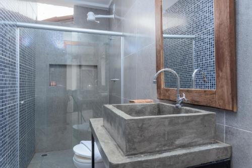 a bathroom with a sink and a toilet at Vila Anauá in Japaratinga