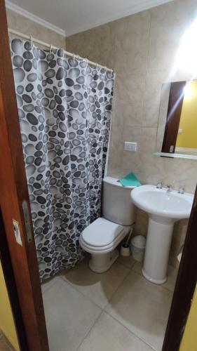 a bathroom with a toilet and a sink at Cabañas Berenice in Malargüe
