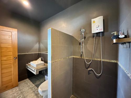 a bathroom with a shower and a toilet at The Sunnery Ville in Lom Kao