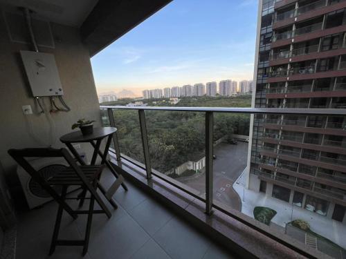 a balcony with a chair and a view of a city at Via Premiere Suite 710B in Rio de Janeiro