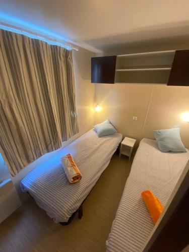 a bedroom with two beds and a window at Séjour inoubliable en Provence, camping 3 étoiles in La Roque-dʼAnthéron