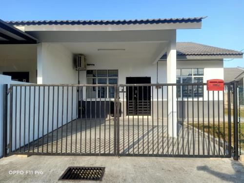 a gate in front of a house at Homestay Izzauni in Kuantan