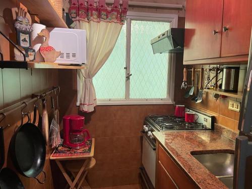 a small kitchen with a stove and a window at Departamento Recoleta. Inmejorable ubicación. in Buenos Aires