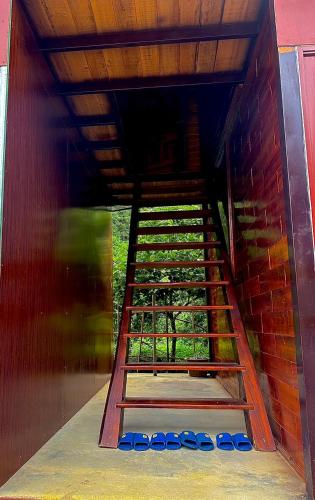 a ladder leading up to a room with a brick wall at Bac Ha Lodge Retreat in Bắc Hà