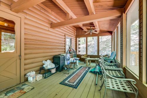 a room with chairs and a table and a ceiling at Near Bushkill Falls Pocono Mountains Cabin! in Bushkill