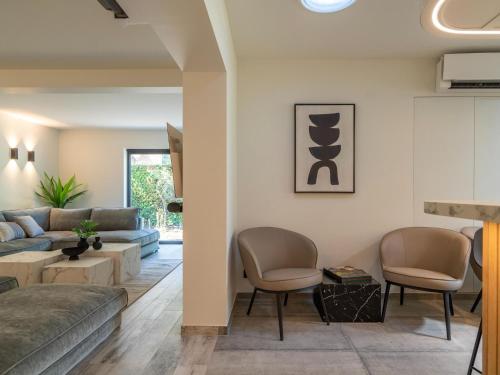 a living room with a couch and chairs at Relax in Kortrijk Luxury in Kortrijk