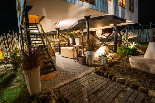 a patio with plants and a building at night at El Santuario in Paracas