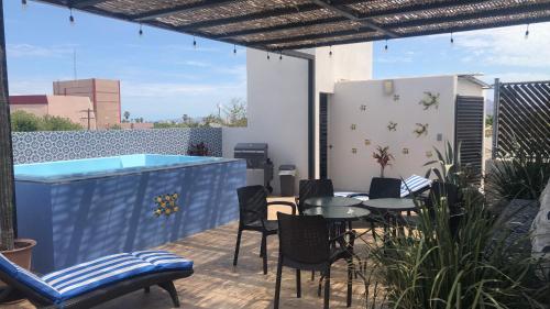 a patio with a table and chairs and a hot tub at TERRARIA APARTMENT NO 6 , NEW AND GREAT LOCATiON in La Paz